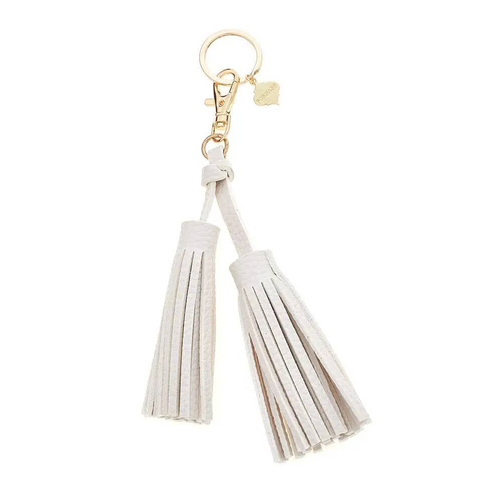 White tassel keychain with gold clasp on a white background