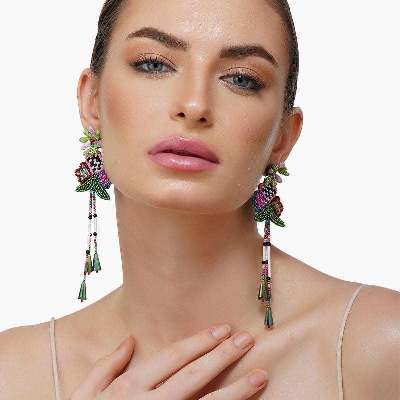 woman wearing beaded flower multi colored dangle earrings