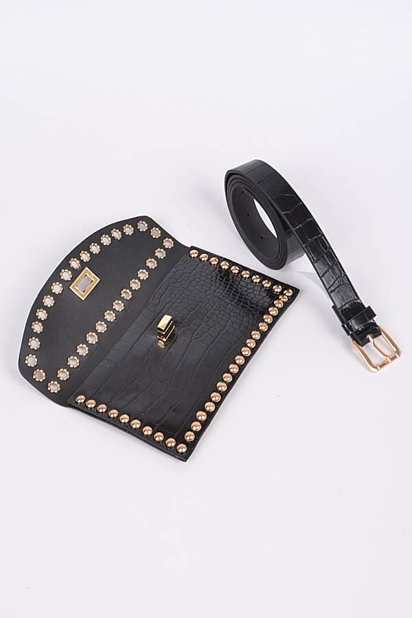 a black croc embossed faux leather clutch bag with gold stud detailing showing the strap removed for versatility against a white background