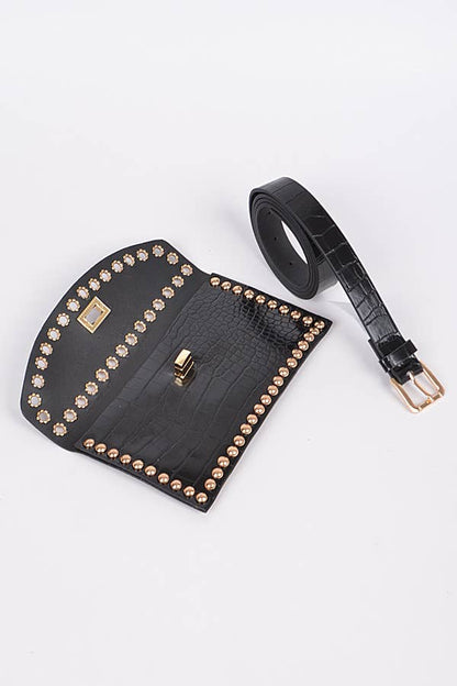 a black croc embossed faux leather clutch bag with gold stud detailing showing the strap removed for versatility against a white background