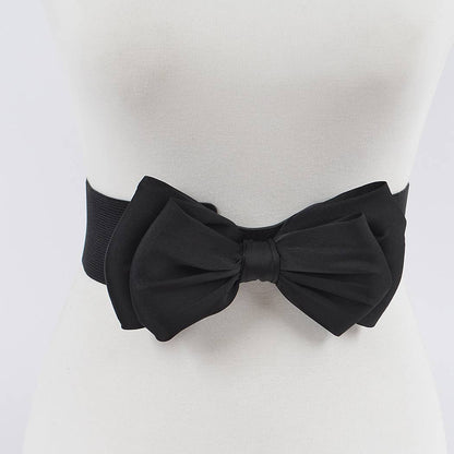 A black bow stretch belt on a mannequin waist