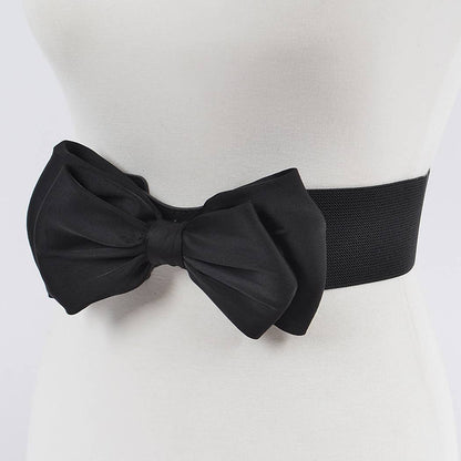 A black bow-tied belt on a mannequin waist.