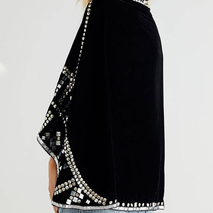 back view of black embellished capelet against a white background