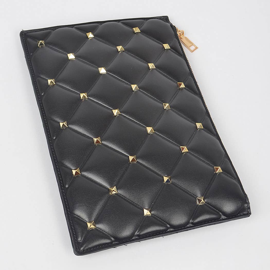 Black vegan leather clutch with gold studs against a white background - flat lay view