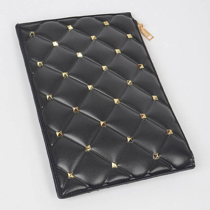 Black vegan leather clutch with gold studs against a white background - flat lay view