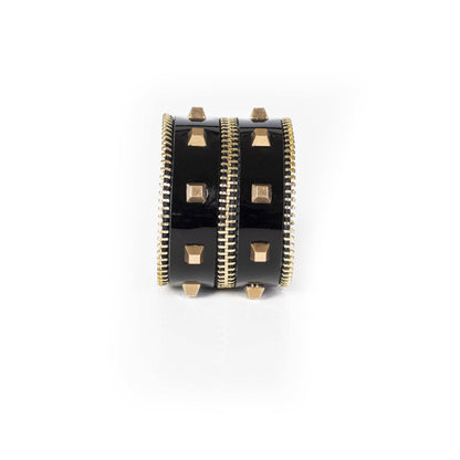 black leather cuff bracelet with gold studded detailing against a white background
