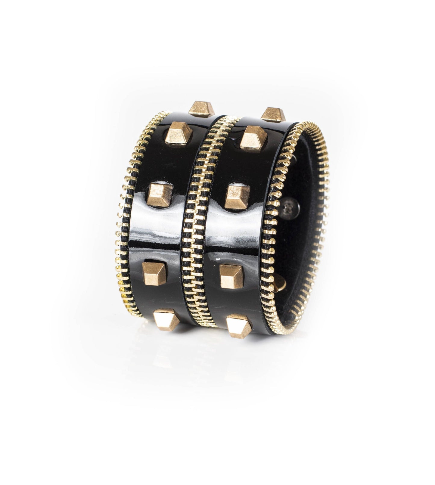 Black leather studded cuff bracelet with gold studs and zipper detail against a white background