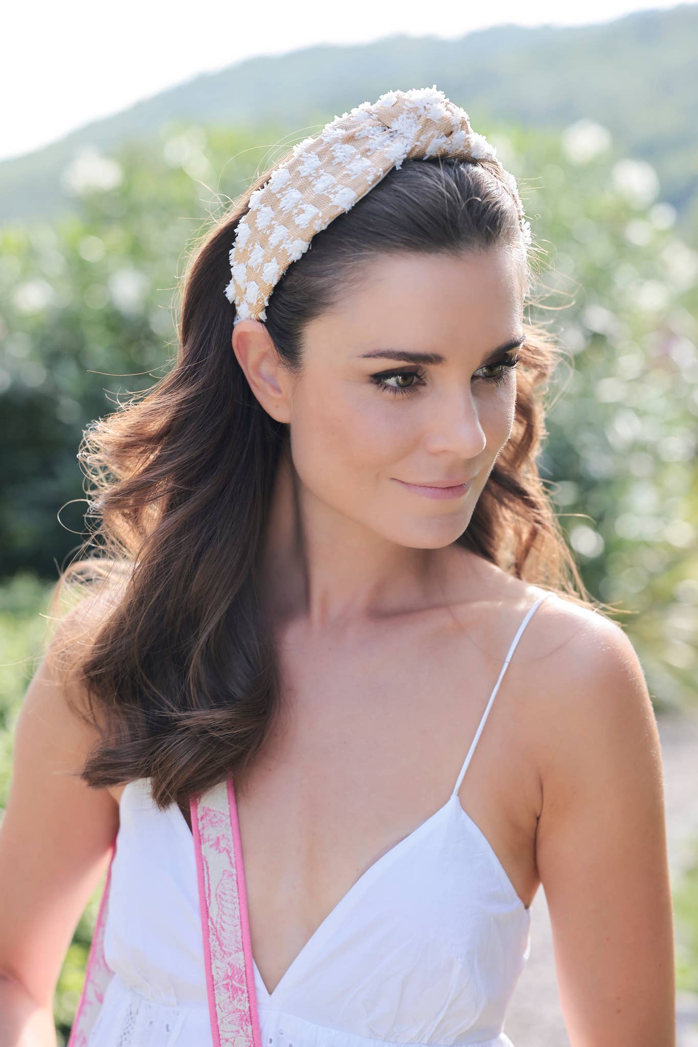 Woman wearing a decorative headband outdoors with blurred background