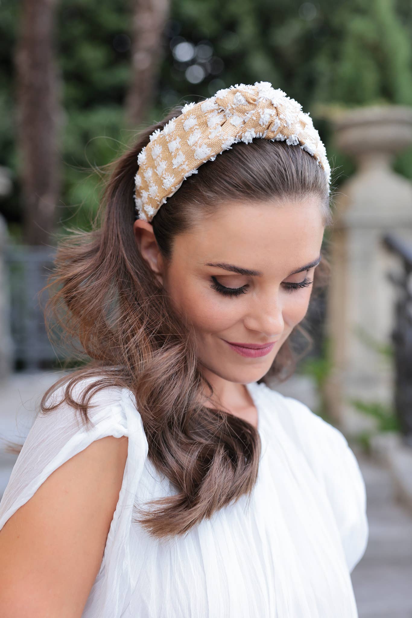 Woman wearing a decorative headband in an outdoor setting