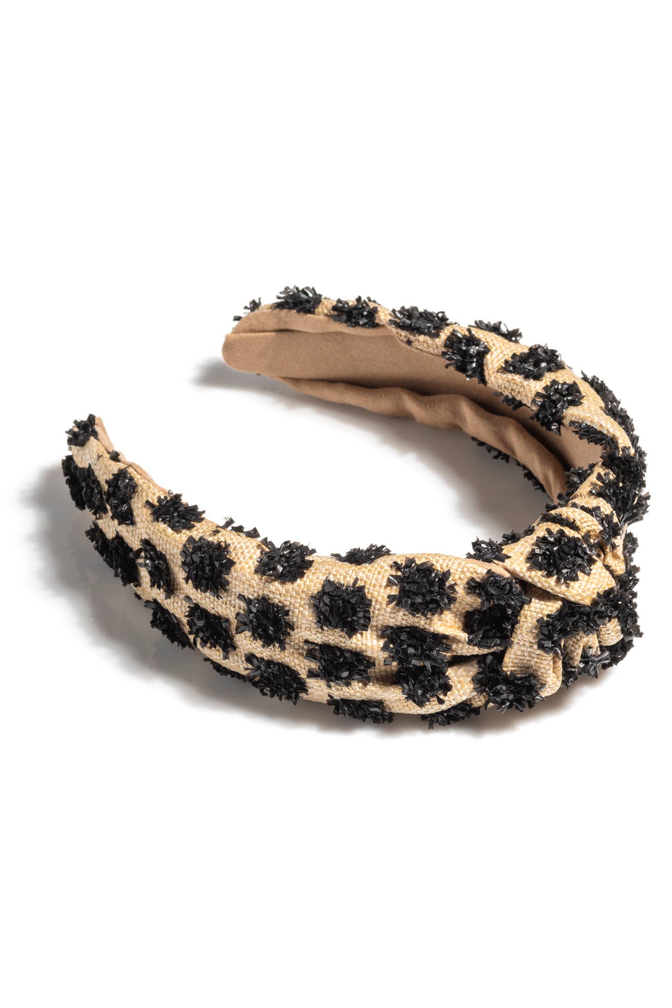 Tufted straw knotted headband in tan with black polka dot accents on white background