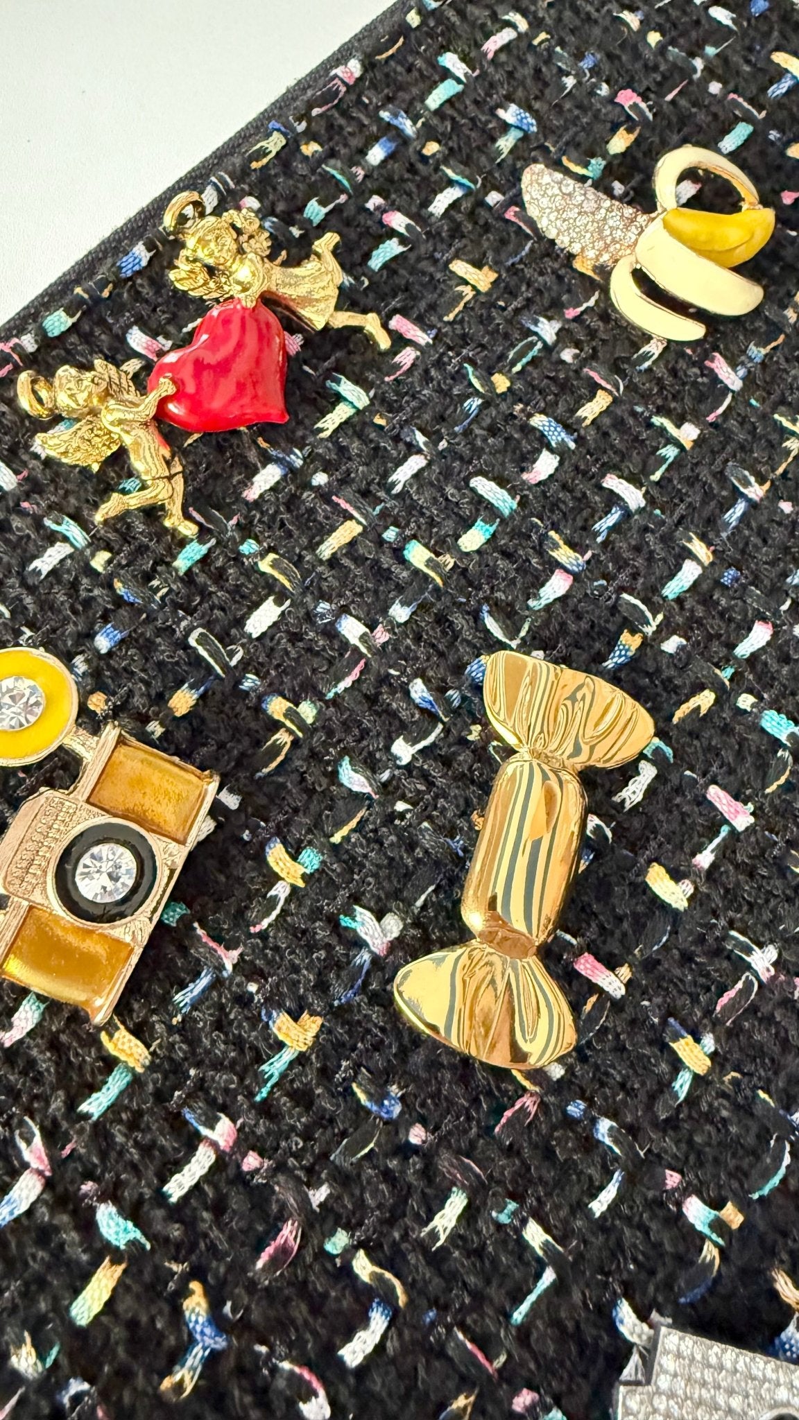 Collection of decorative brooches on a textured fabric background