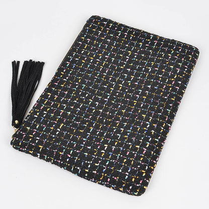 black tweed pouch with black tassel laying against a white background