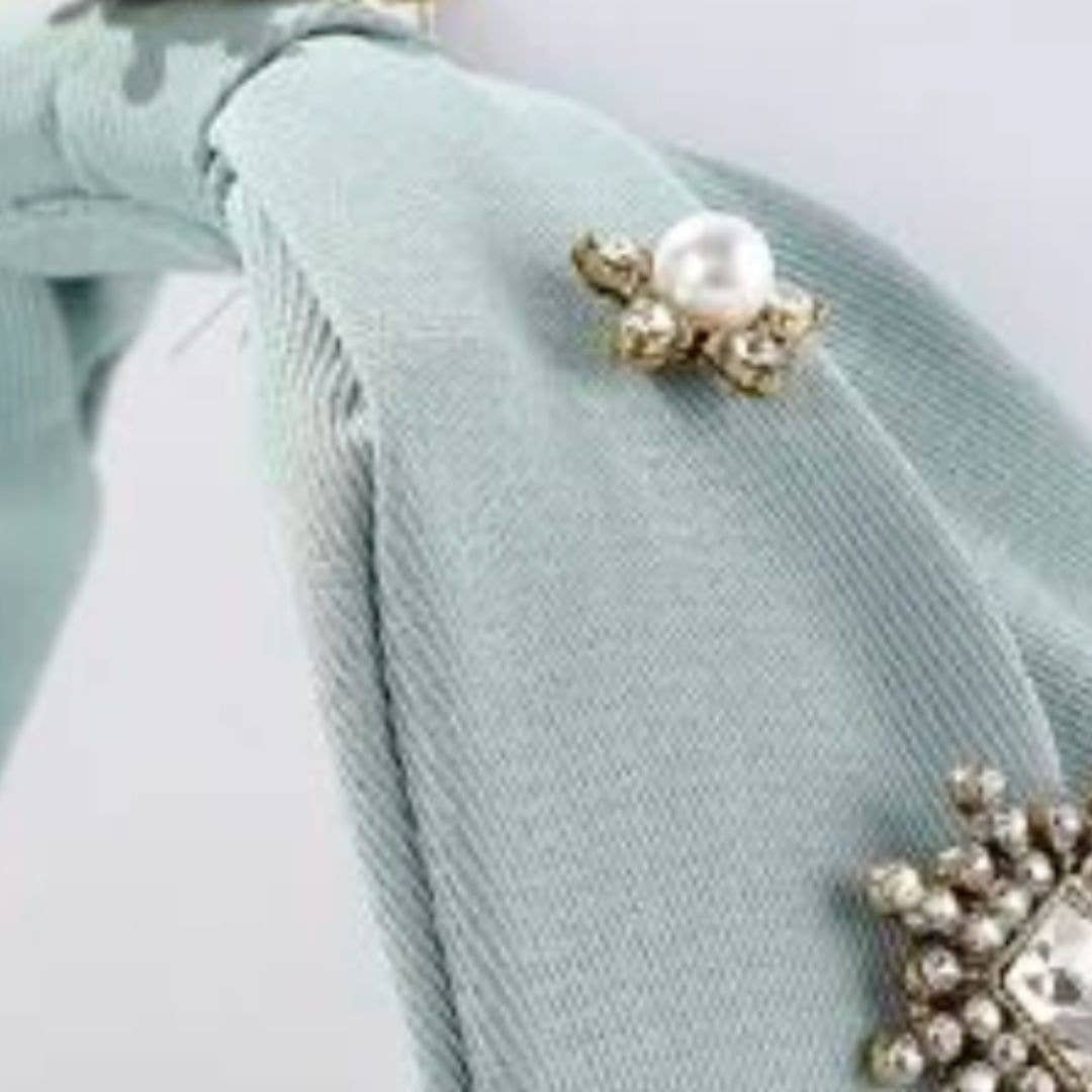 up close detail view of light blue headband and pear and crystal embellishment