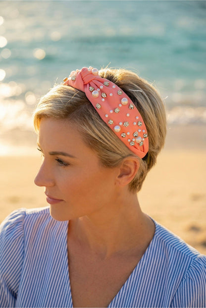Woman wearing a pearl and rhinestone embellished headband on a beach