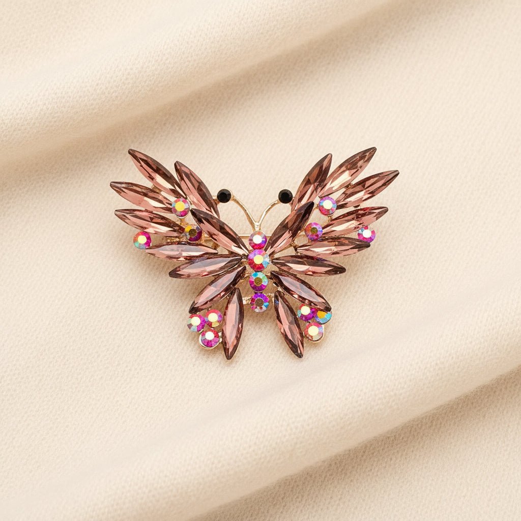 Decorative butterfly brooch with gemstones laying on an ivory sweater fabric