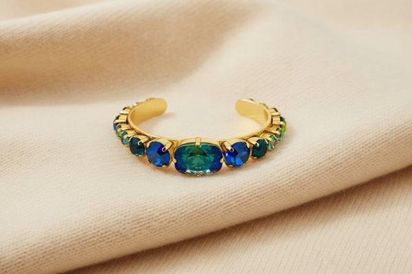 Aqua verde crystal cuff bracelet with iridescent blue-green stones in antique gold setting