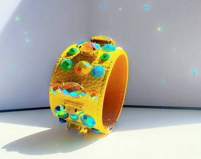 Yellow leather bracelet with colorful beads on a light gray background