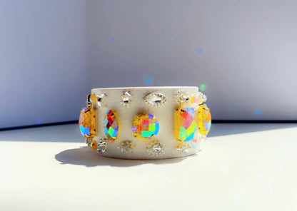 ivory leather bracelet with colorful beads and rhinestones on a white background