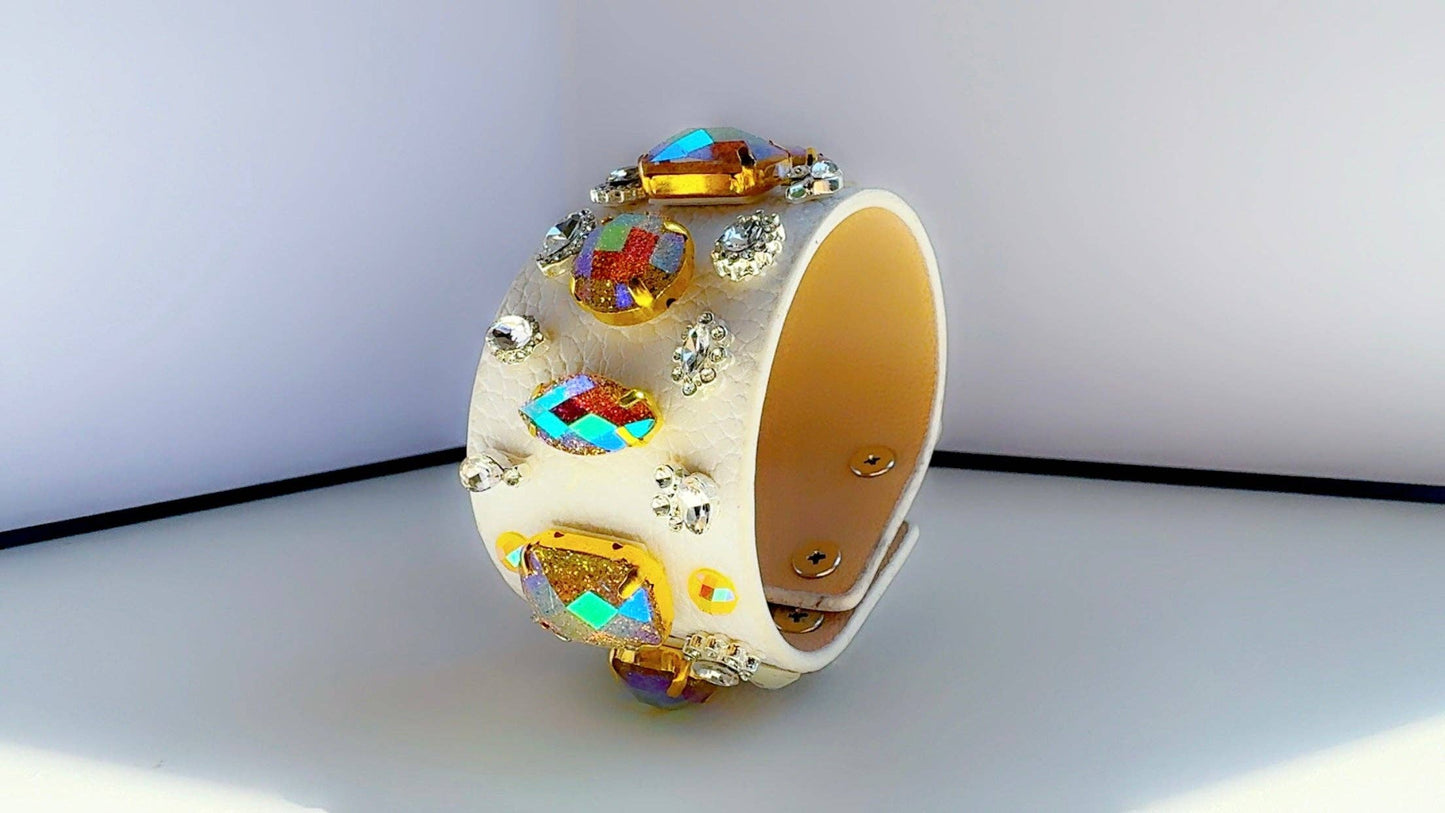 Decorative white leather bracelet with colorful gemstones on a white background