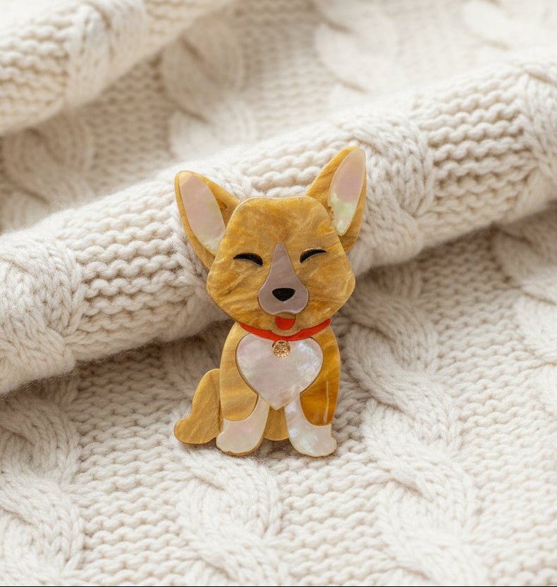 A Corgi dog brooch on an ivory cable knit sweater material background