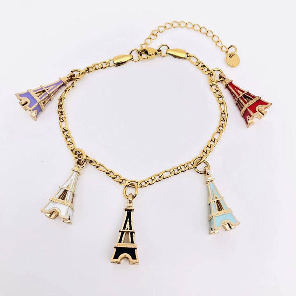 Gold chain bracelet with five colorful enamel Eiffel Tower charms on white background