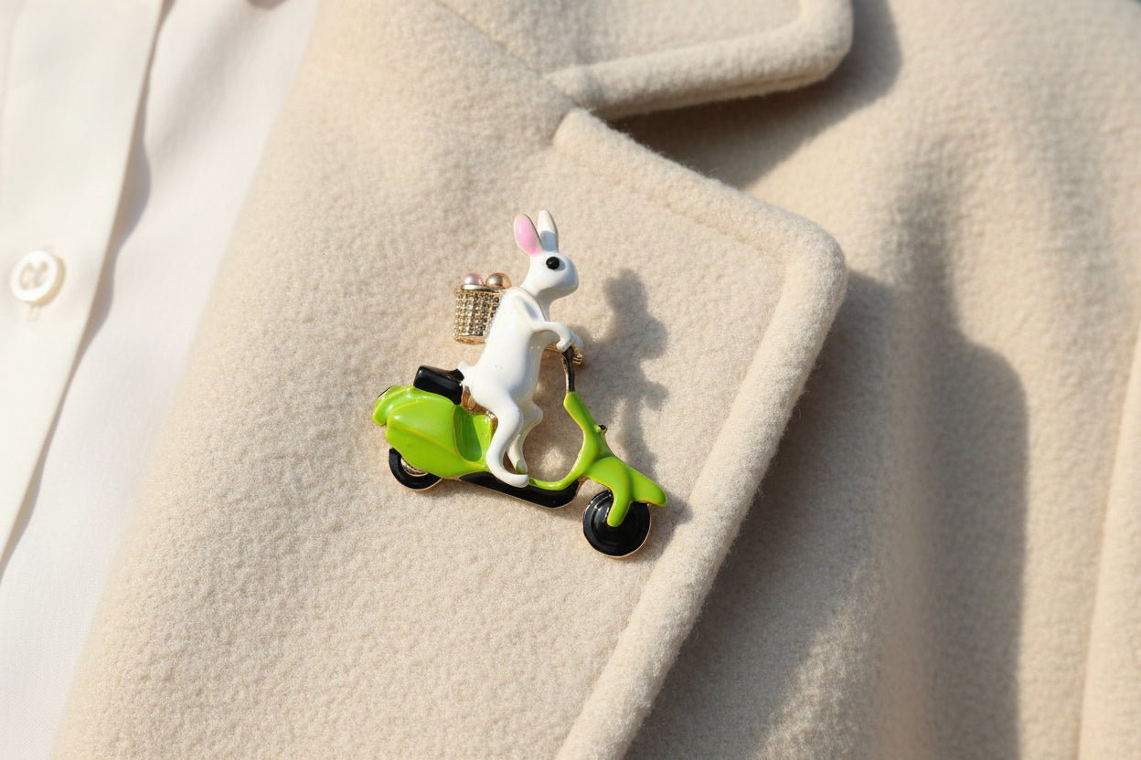rabbit on a scooter brooch on the lapel of an ivory coat