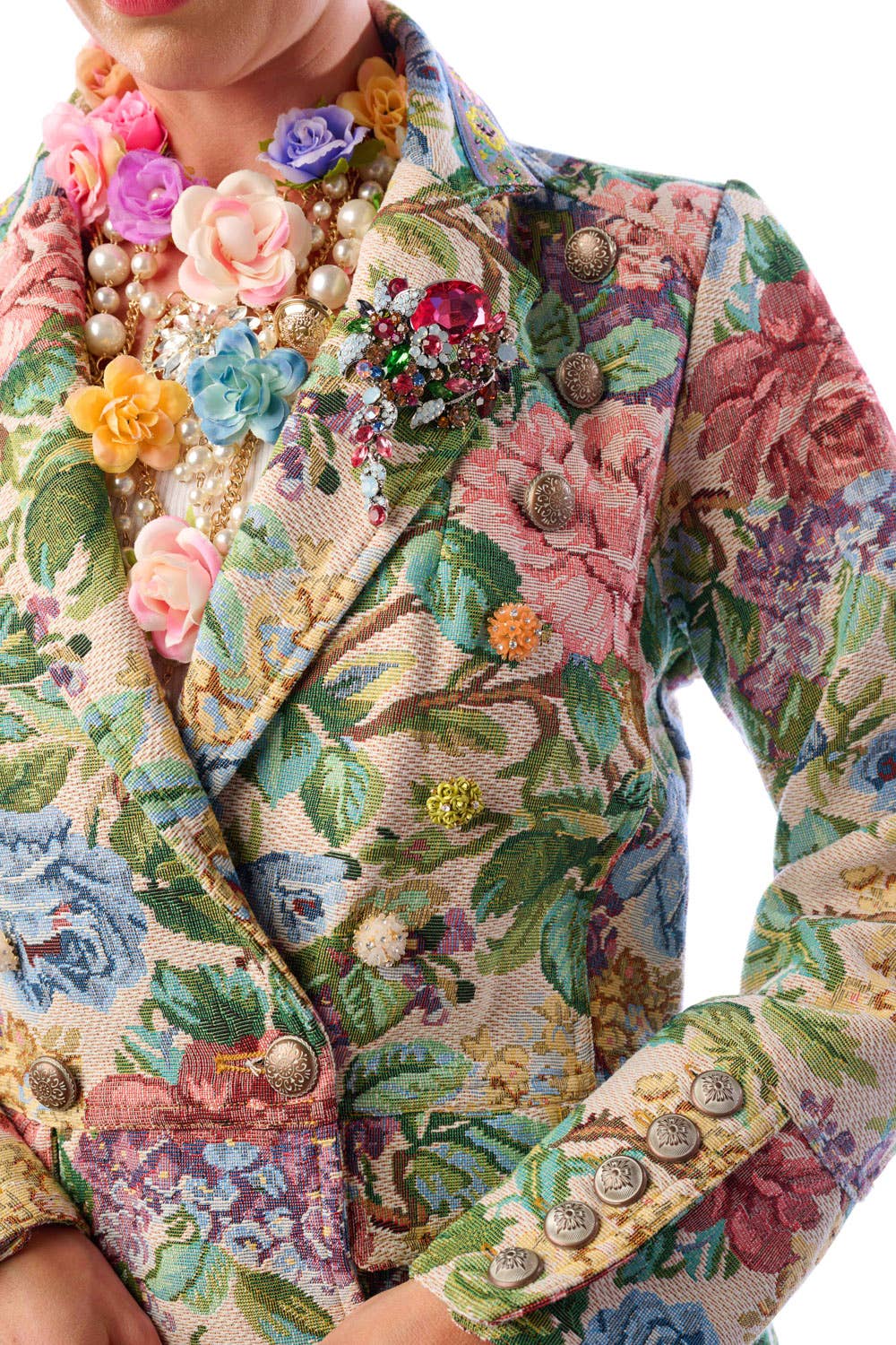 Crystal brooch detail on floral jacquard coat lapel — close-up embellishment