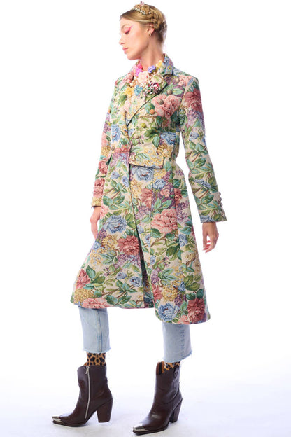 Side view of woman wearing a floral coat on a white background