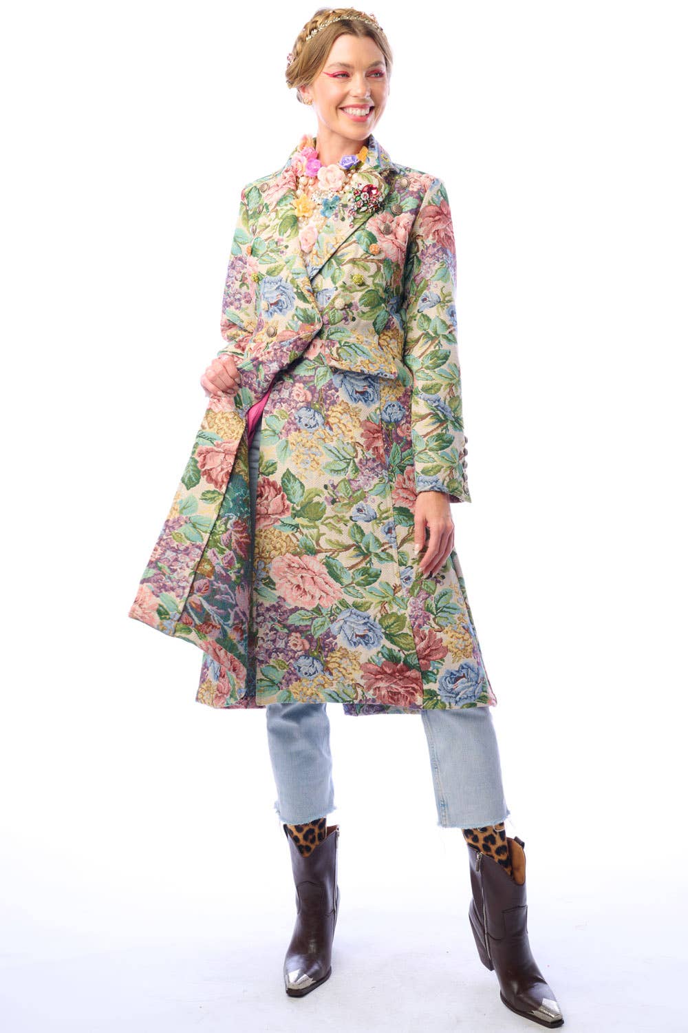 Woman wearing a colorful floral coat showing the lining on a white background