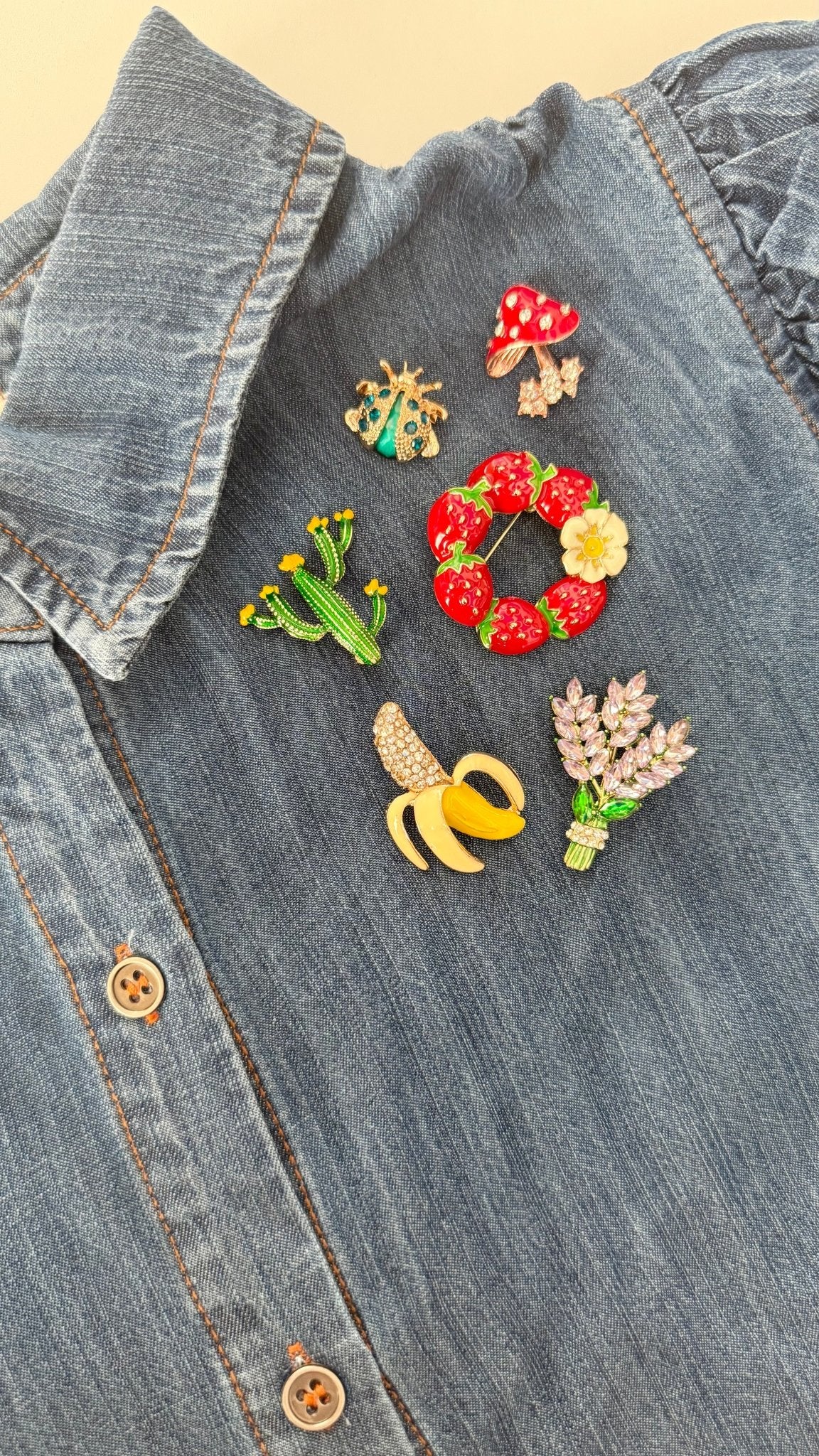 Colorful brooches on a denim shirt