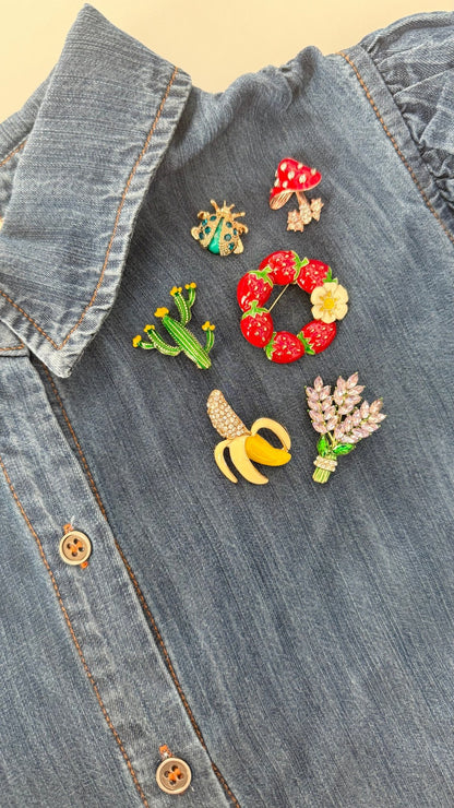 Colorful brooches on a denim shirt
