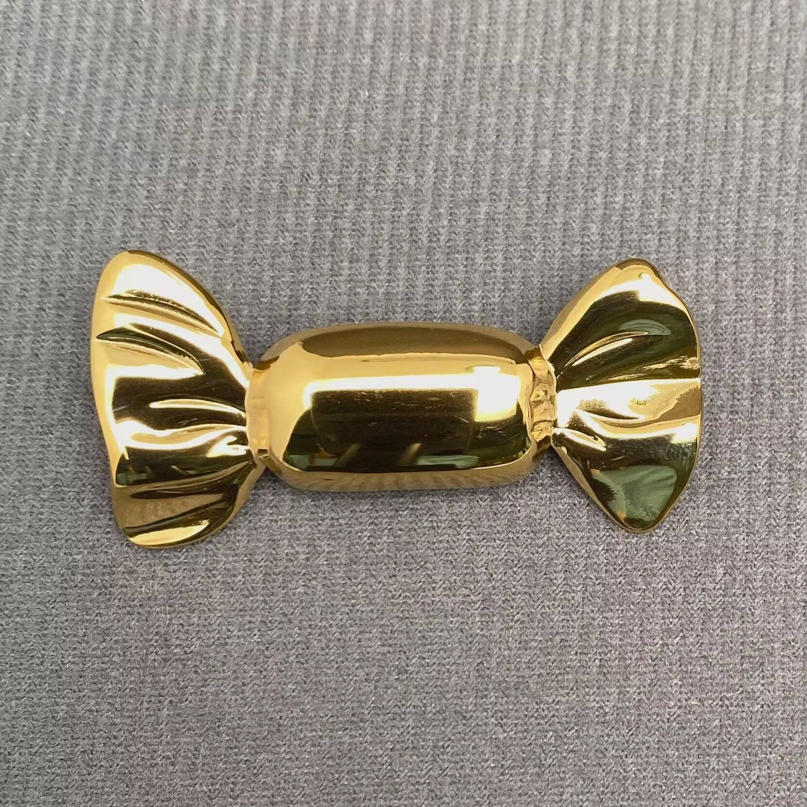 Gold candy wrapper shaped brooch