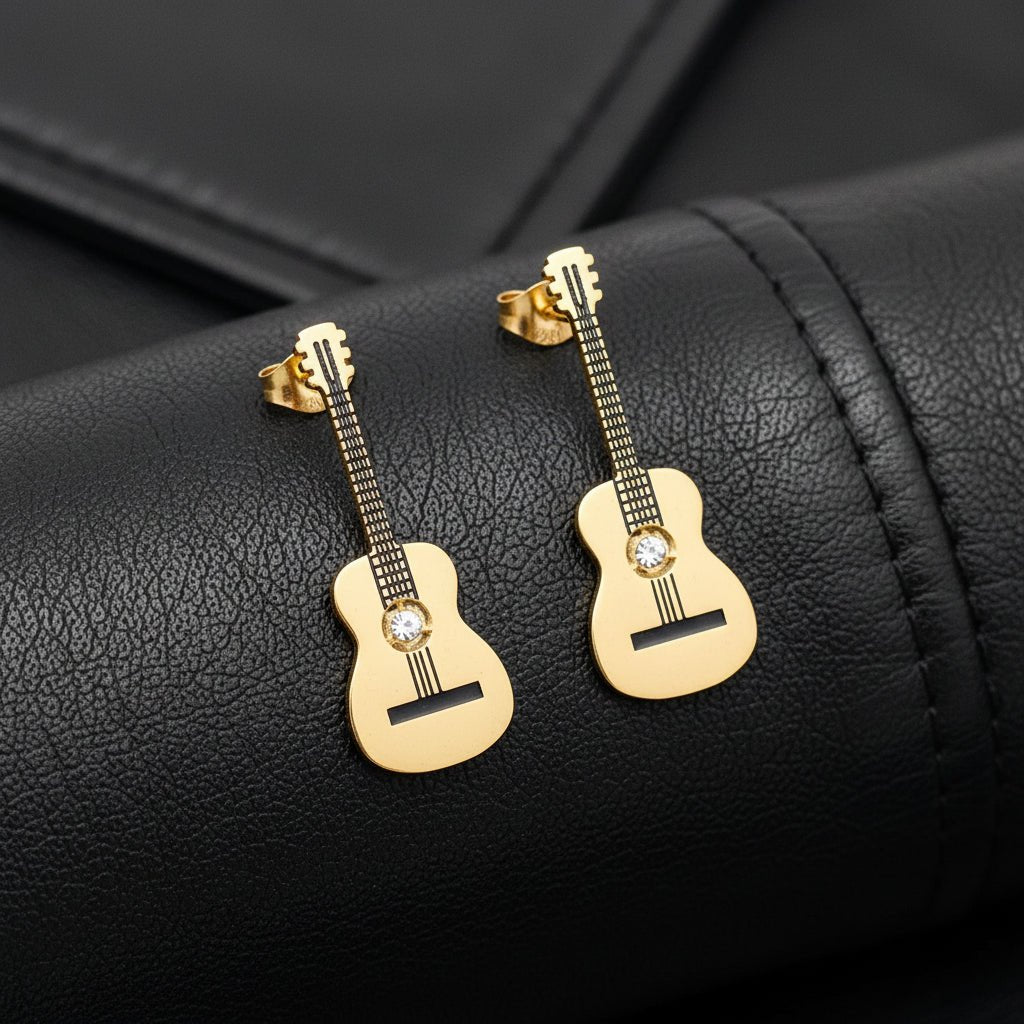 Gold Guitar-shaped earrings on a black leather material background
