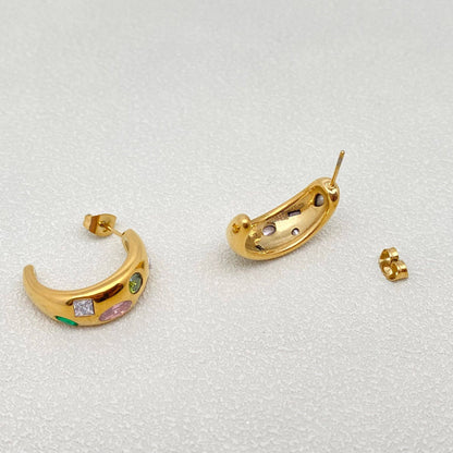 the side and back view of a pair of gold multi color inlaid crystal hoop earrings against a white background