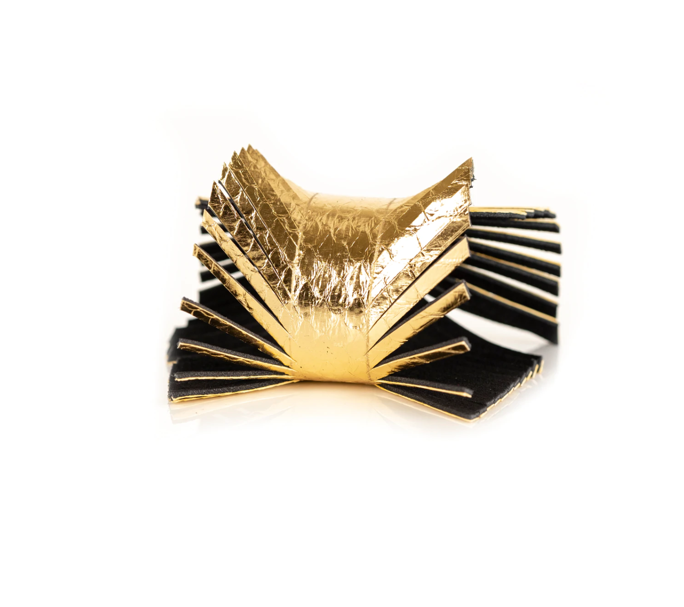 Gold snakeskin embossed leather bracelet with fringe detail against a white background