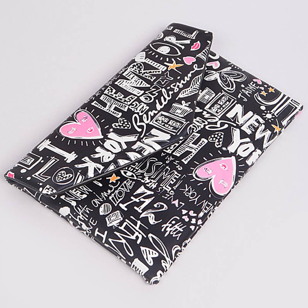 Graffiti print envelope clutch — front flat lay view showing colorful doodle print on black background