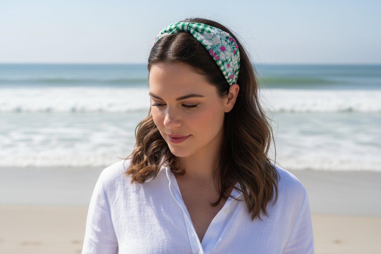woman wearing a green gingham beaded headband with a white blouse in a beach setting