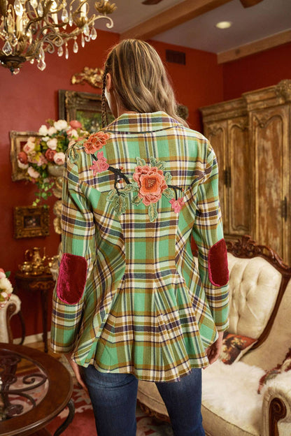 back view of woman wearing green plaid blazer with floral embroidery and jeans