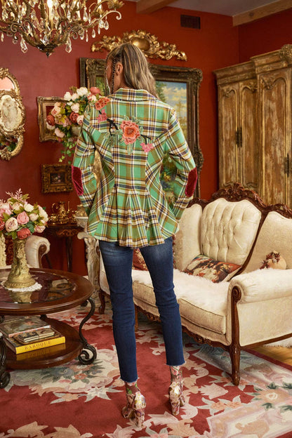 back view of woman wearing green plaid blazer with floral embroidery and jeans