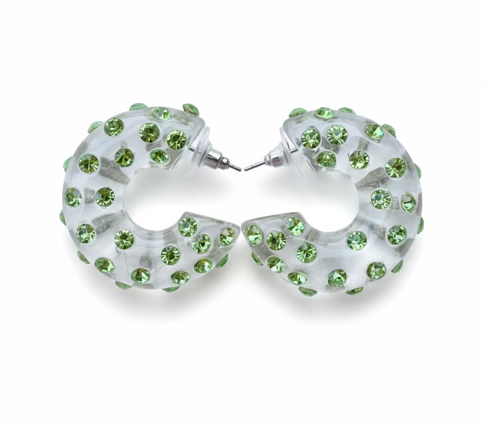 Hoop earrings with green gemstones on a light blue background
