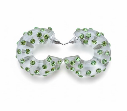 Hoop earrings with green gemstones on a light blue background