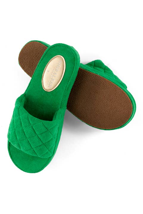 Green quilted terrycloth pool slides shown from side angle to show EVA sole against a white background 