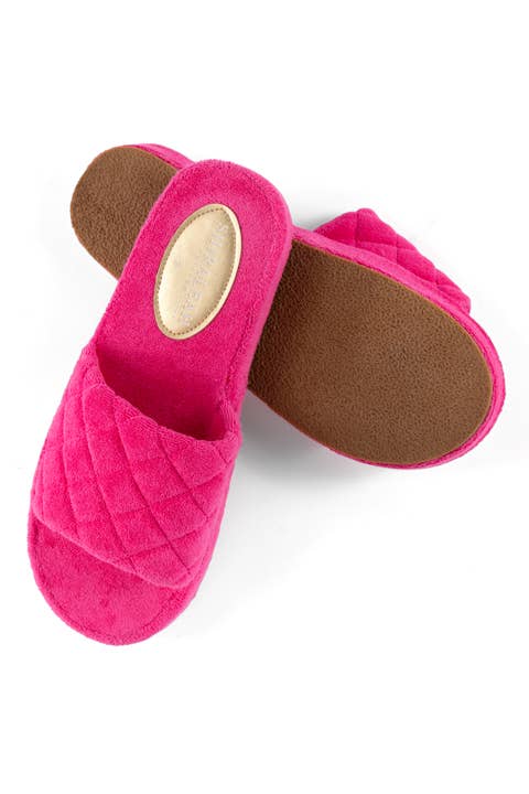 Angled view of hot pink terrycloth pool slides showing durable EVA sole against a white background 
