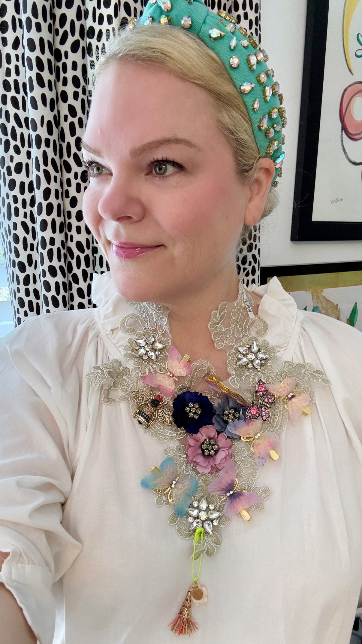 Woman wearing statement lace necklace with floral and crystal details