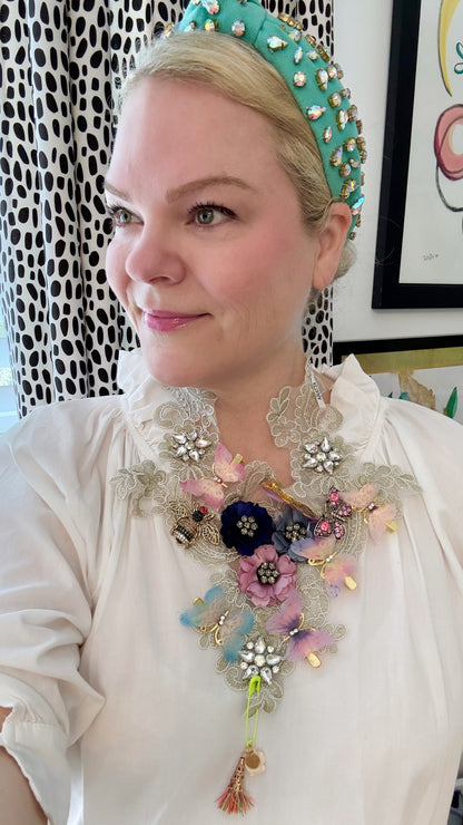 Woman wearing statement lace necklace with floral and crystal details