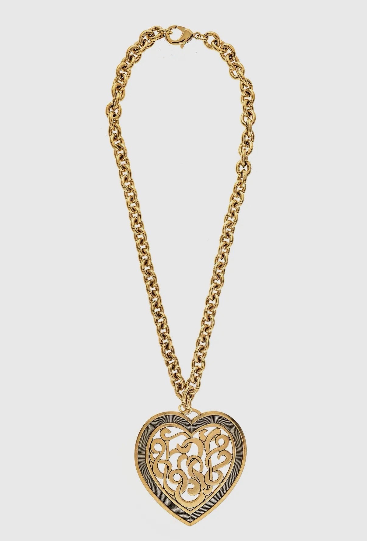 Large gold filigree heart pendant necklace with chunky chain on white background