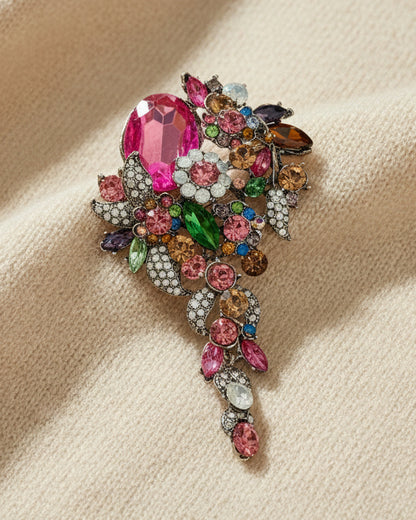 Rainbow crystal cascade brooch with multicolor jewels on  ivory background