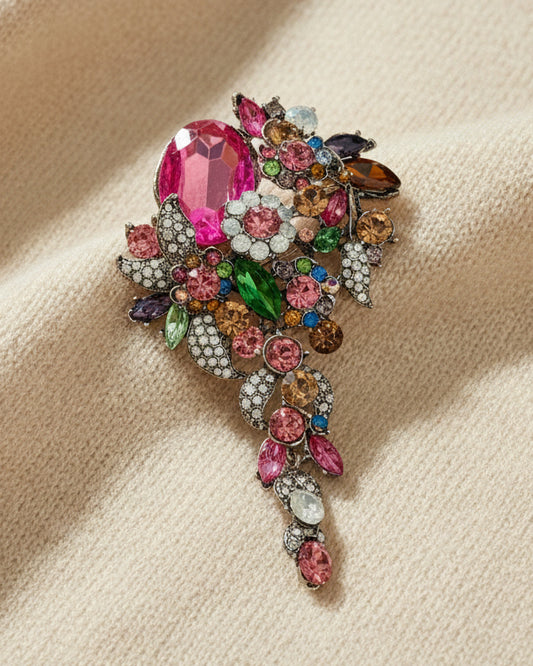 Rainbow crystal cascade brooch with multicolor jewels on  ivory background