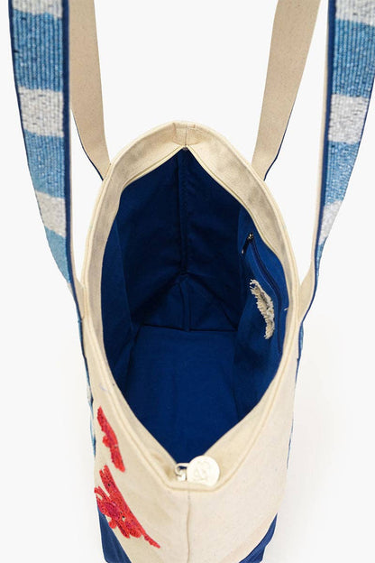 Blue poly-lined interior with zipper pocket inside large canvas tote bag