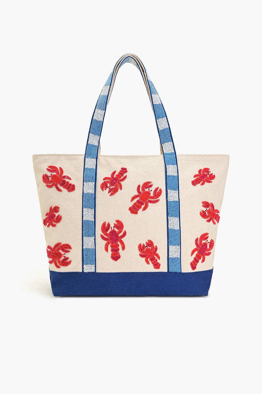 A large tote bag with a white canvas base and blue straps and bottom. The bag has a red lobster print on the front and a beaded blue-and-white shoulder handle.